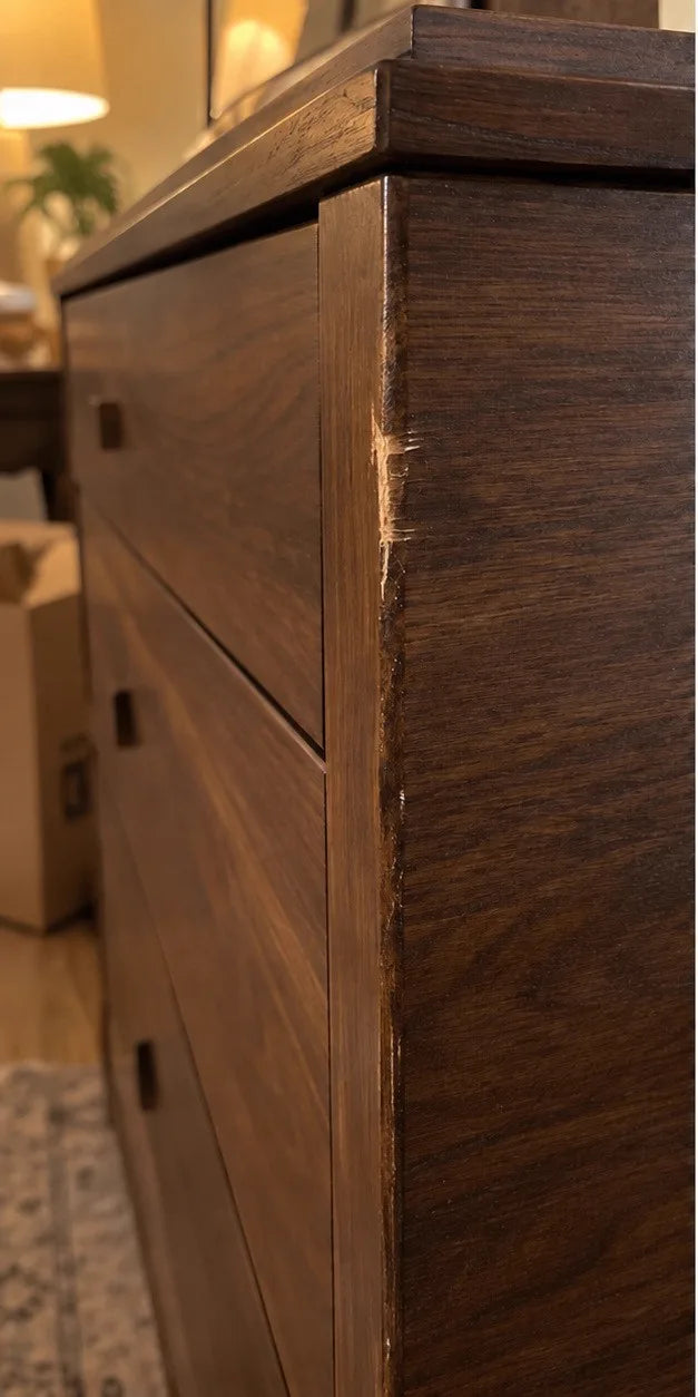 Moving-day gouge on a walnut dresser corner before ScratchZero repair